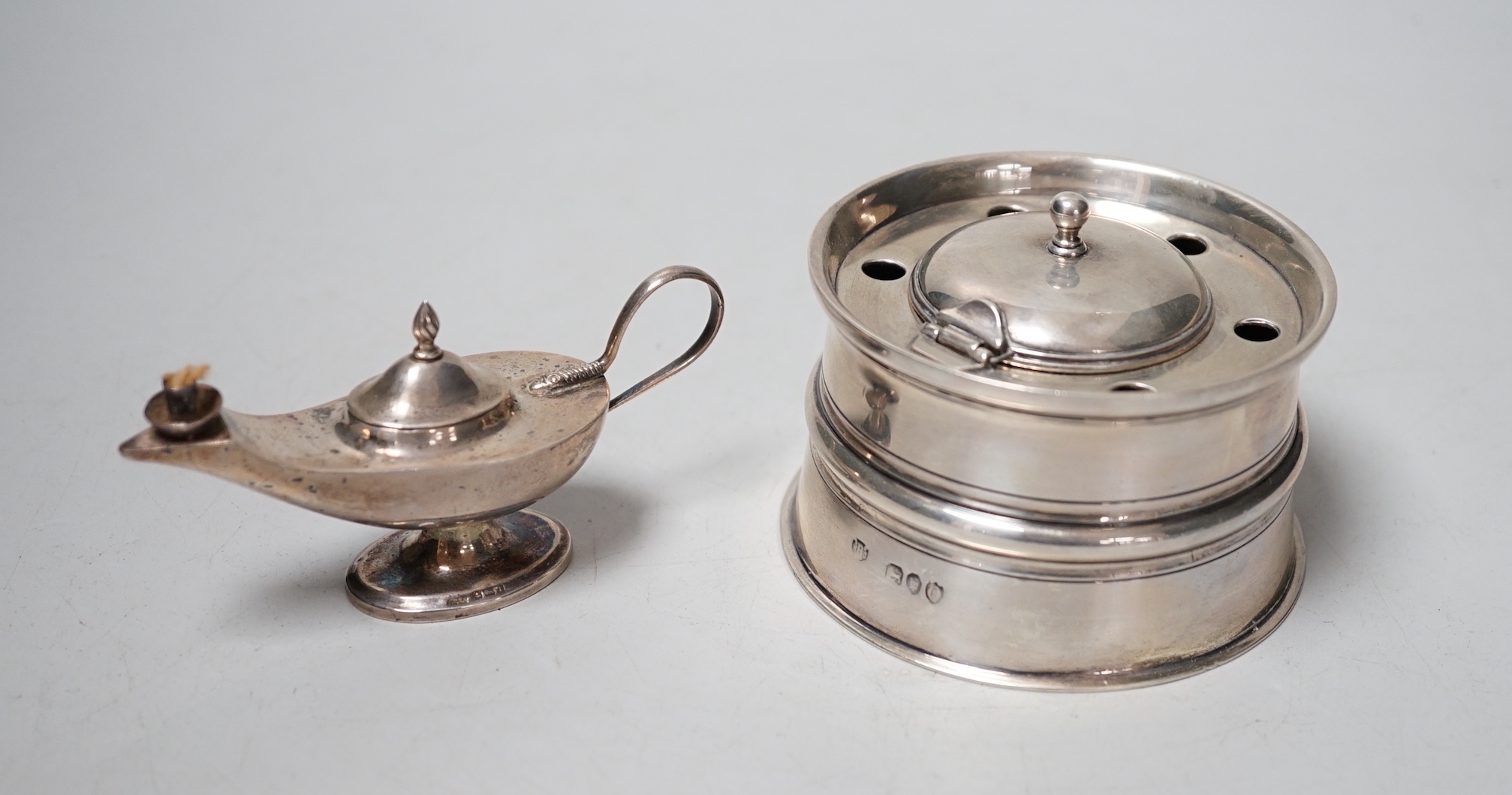 A late Victorina silver inkwell with five pen recesses, William & John Barnard, London 1889, diameter 86mm, and a small George V silver 'Aladdin's lamp' lighter.